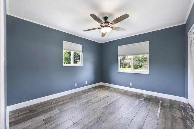 spare room featuring ceiling fan, wood-type flooring, and ornamental molding