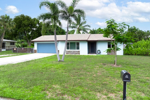 ranch-style house with a garage and a front lawn