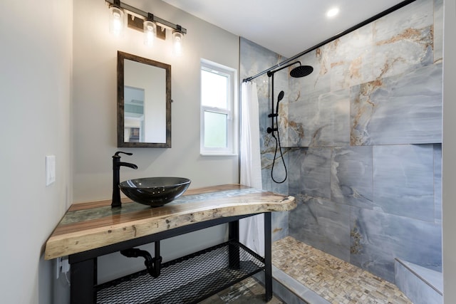 bathroom featuring vanity and a tile shower