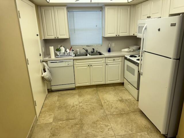 kitchen with white cabinets, white appliances, light countertops, and a sink