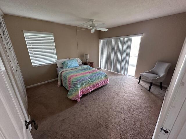 bedroom featuring carpet, ceiling fan, a textured ceiling, and baseboards