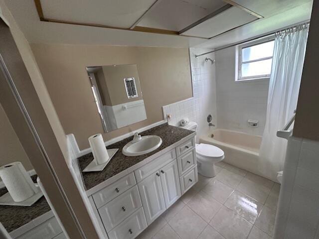 full bath featuring toilet, shower / tub combo, vanity, and tile patterned floors