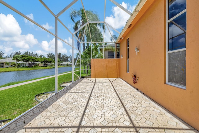 unfurnished sunroom with a water view