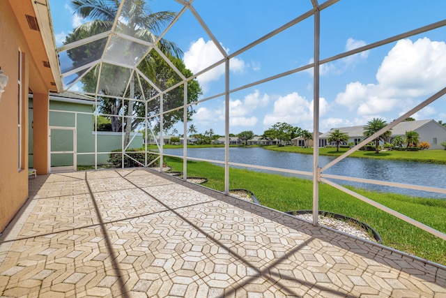 unfurnished sunroom featuring a water view