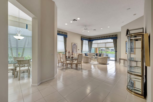 living room with ceiling fan and light tile patterned floors