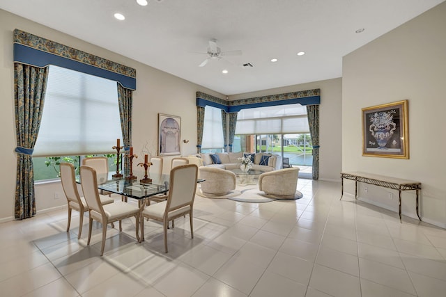 tiled dining room with ceiling fan and a healthy amount of sunlight