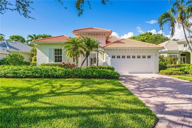 mediterranean / spanish-style house with a front yard and a garage