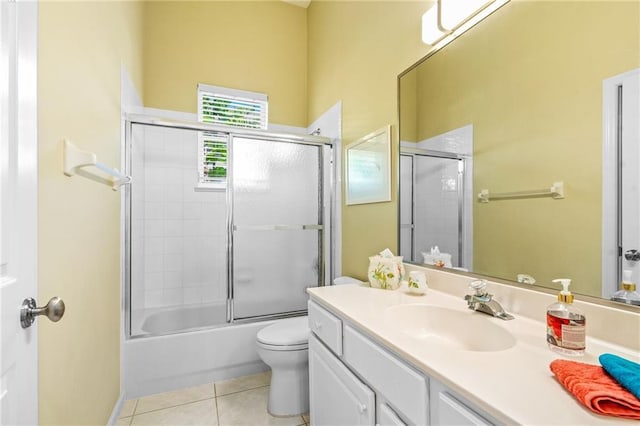 full bathroom with toilet, combined bath / shower with glass door, tile patterned floors, and vanity