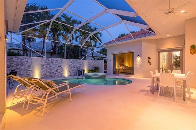 view of pool featuring ceiling fan, glass enclosure, an in ground hot tub, and a patio