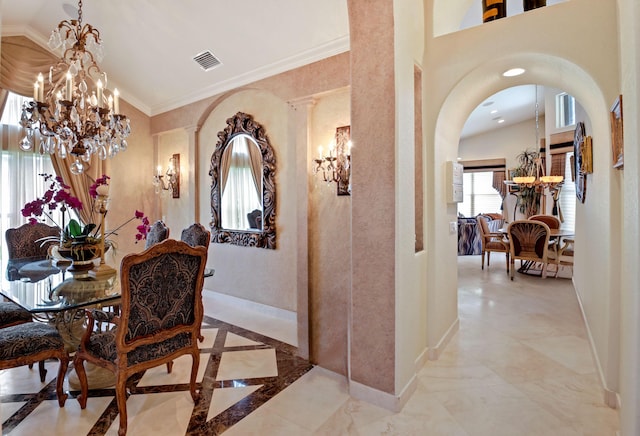 dining area with crown molding and an inviting chandelier