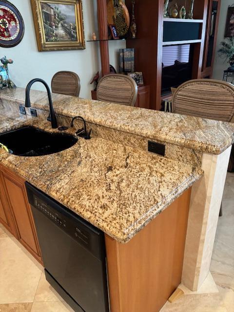 kitchen with light stone countertops, black dishwasher, light tile patterned flooring, and sink