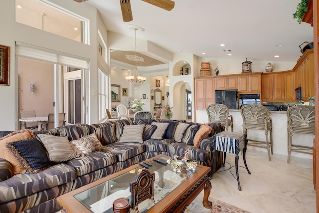 11420 Ohanu Cir, Boynton Beach, FL 33437 - living room featuring a chandelier, ceiling fan, arched walkways, a towering ceiling, and recessed lighting