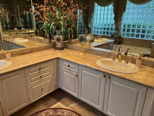 bathroom featuring vanity and a washtub