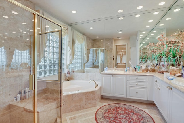 bathroom featuring vanity and shower with separate bathtub