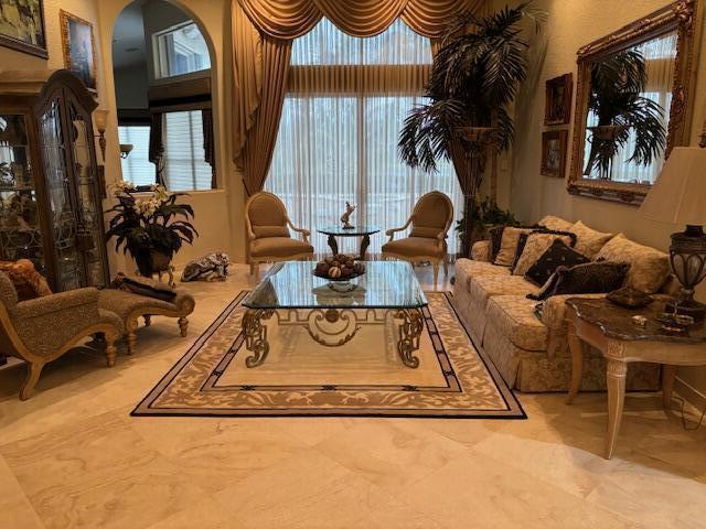 sitting room with a towering ceiling