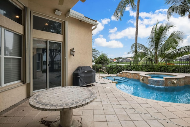 view of swimming pool with an in ground hot tub, a patio, pool water feature, and grilling area