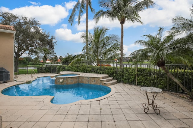 view of pool featuring area for grilling, a patio area, and an in ground hot tub