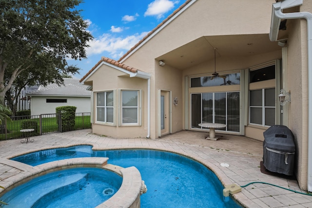 view of swimming pool with area for grilling, an in ground hot tub, and a patio