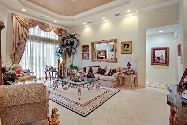 living room featuring a tray ceiling, a towering ceiling, and ornamental molding