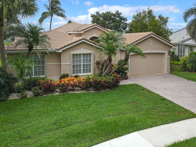 11420 Ohanu Cir, Boynton Beach, FL 33437 - mediterranean / spanish home with driveway, a garage, a front lawn, a tile roof, and stucco siding