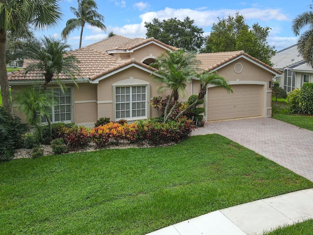 view of front of house with a garage and a front lawn