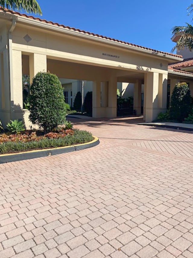 11420 Ohanu Cir, Boynton Beach, FL 33437 - exterior space with stucco siding and curved driveway