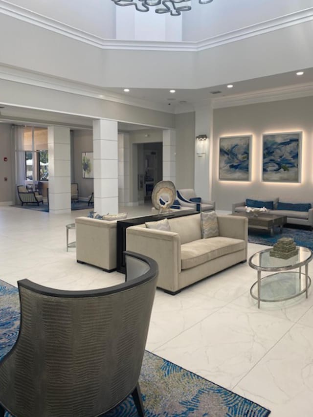 living room featuring a towering ceiling and ornamental molding