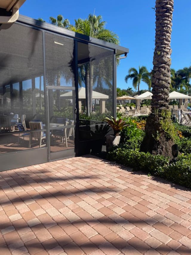 view of patio with a sunroom