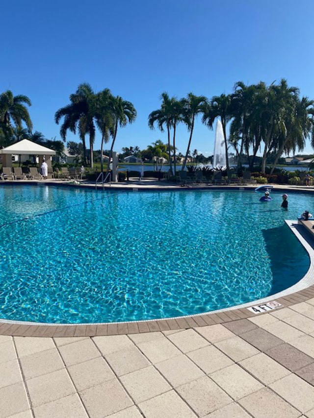 11420 Ohanu Cir, Boynton Beach, FL 33437 - community pool with a patio area