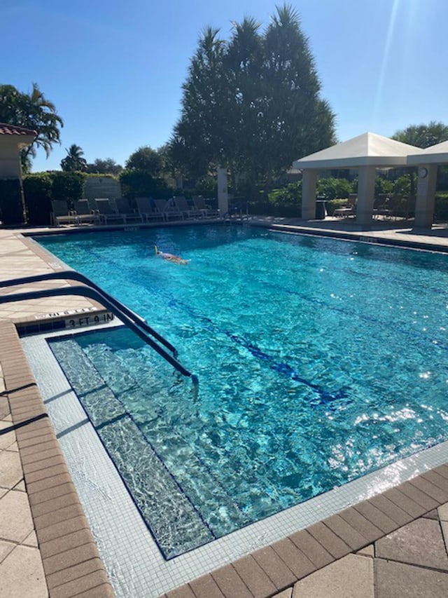 view of pool featuring a gazebo and a patio area