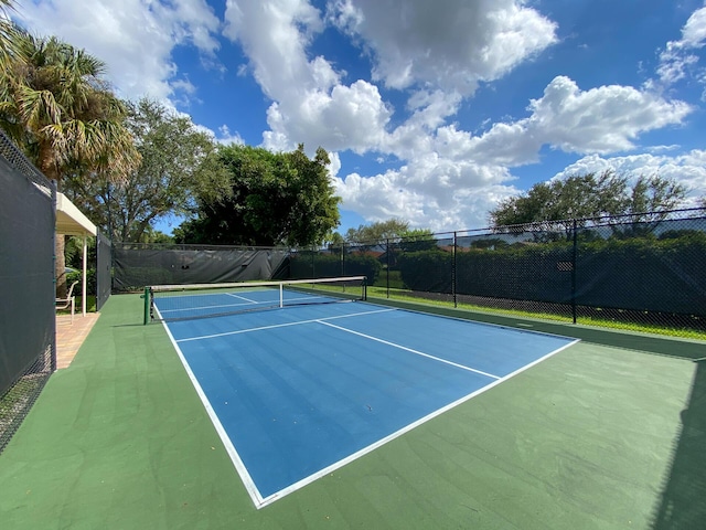 view of tennis court with basketball hoop