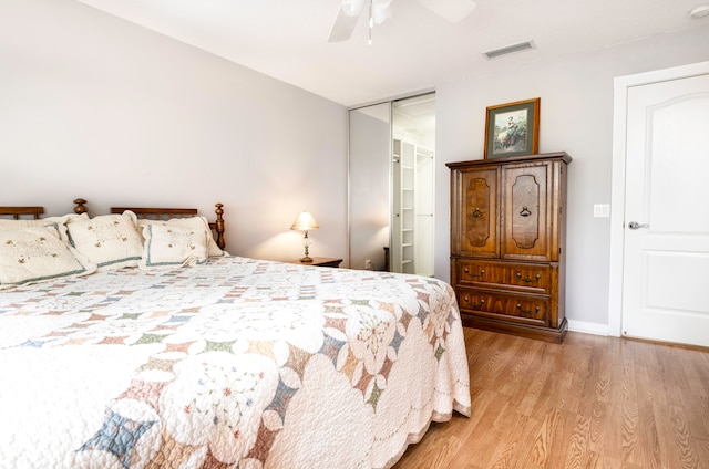 bedroom featuring light hardwood / wood-style flooring, a closet, and ceiling fan