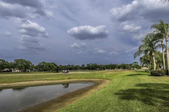 view of home's community featuring a lawn and a water view