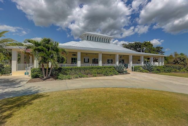 view of front of home featuring covered porch and a front yard