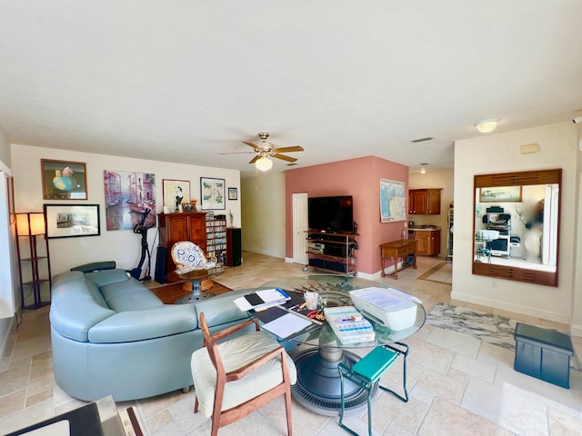 living room with light tile patterned flooring and ceiling fan