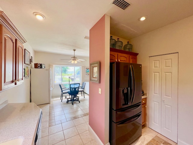 clothes washing area with light tile patterned floors and ceiling fan