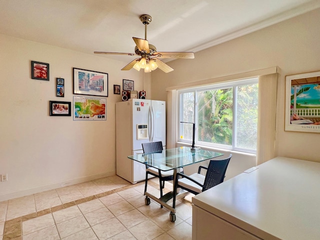 dining space with ceiling fan and light tile patterned floors