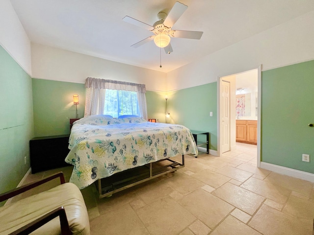 tiled bedroom featuring ensuite bath and ceiling fan