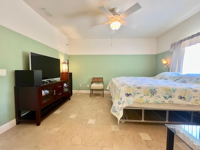 tiled bedroom featuring ceiling fan