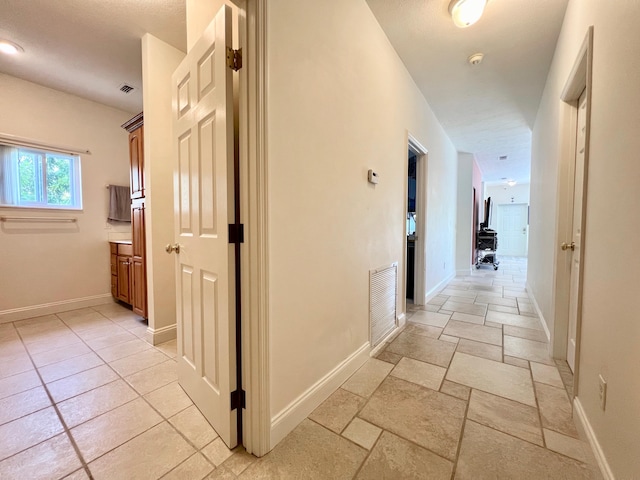 hallway with light tile patterned flooring