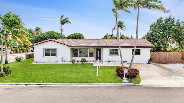 ranch-style home featuring a front yard