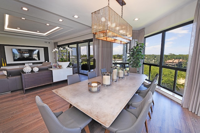 dining area featuring crown molding, dark hardwood / wood-style floors, and a tray ceiling