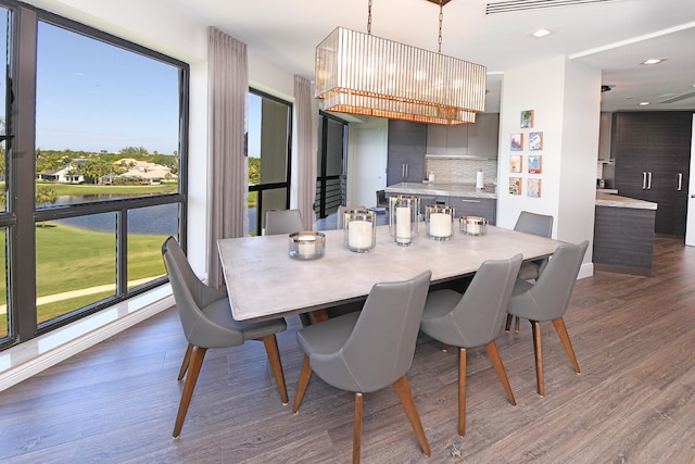 dining room with dark wood-type flooring and a chandelier