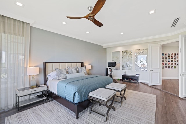 bedroom featuring ceiling fan, hardwood / wood-style flooring, and ornamental molding