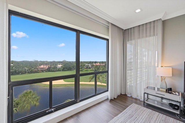 sunroom featuring a water view