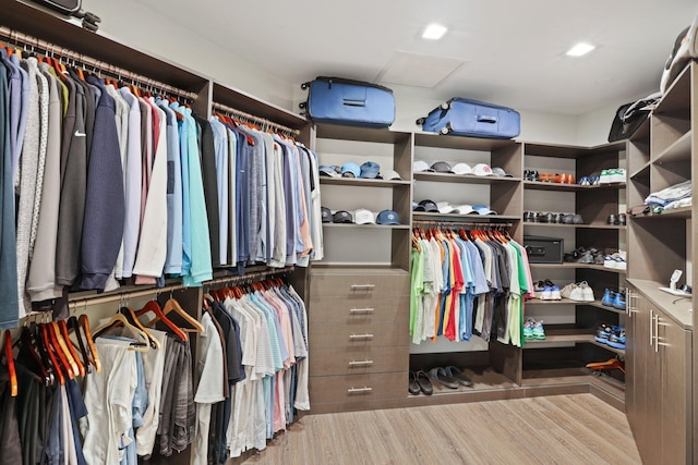 spacious closet with light hardwood / wood-style floors