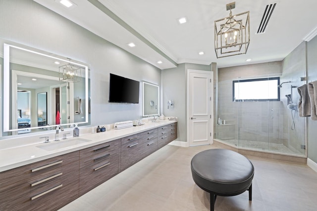 bathroom featuring vanity, ornamental molding, and a shower with door