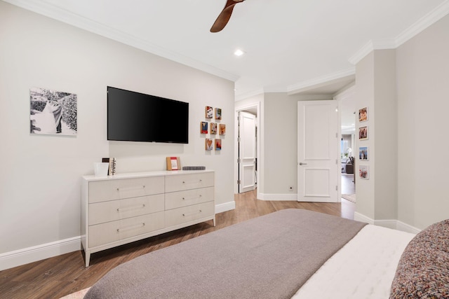 bedroom with ornamental molding, wood-type flooring, and ceiling fan