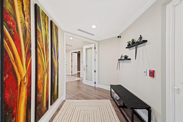 corridor with crown molding and wood-type flooring