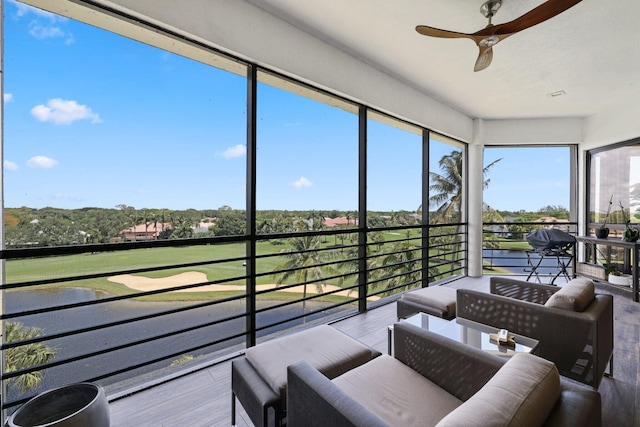 sunroom featuring ceiling fan and plenty of natural light